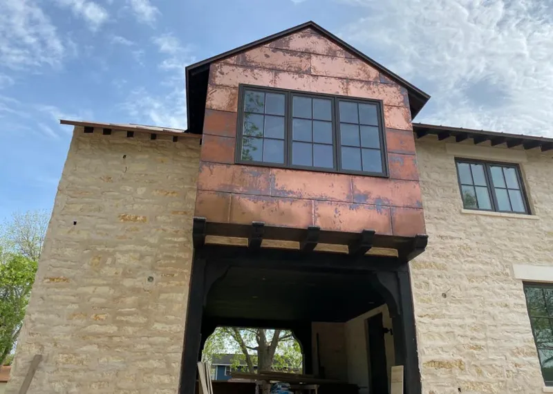 Copper metal panel facade on a stone building for Metal Roof Coating in Decatur